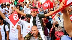 Demonstrators attend a protest against Tunisian President Kais Saied in Tunis on September 26