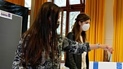 A woman casts her ballot for the abortion referendum at a polling station in San Marino, Sunday, Sept. 26, 2021. 