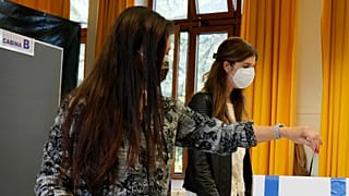 A woman casts her ballot for the abortion referendum at a polling station in San Marino, Sunday, Sept. 26, 2021.