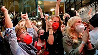 Supporters react after German parliament election at the Social Democratic Party, SPD, headquarters in Berlin, Sunday, Sept. 26, 202