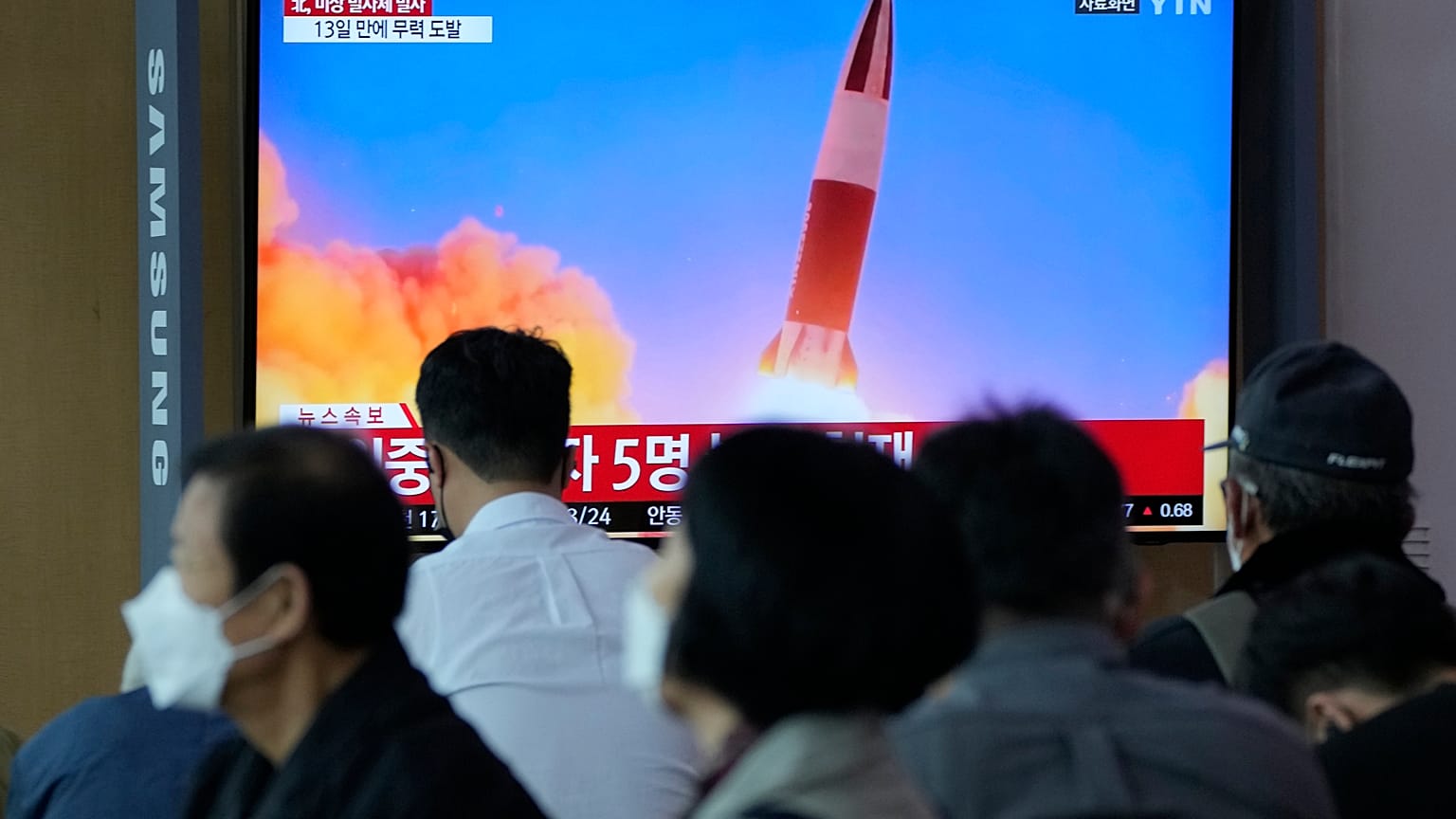 People watch a TV showing a file image of North Korea's missile launch during a news program at the Seoul Railway Station in Seoul, South Korea, Sept. 28, 2021. 