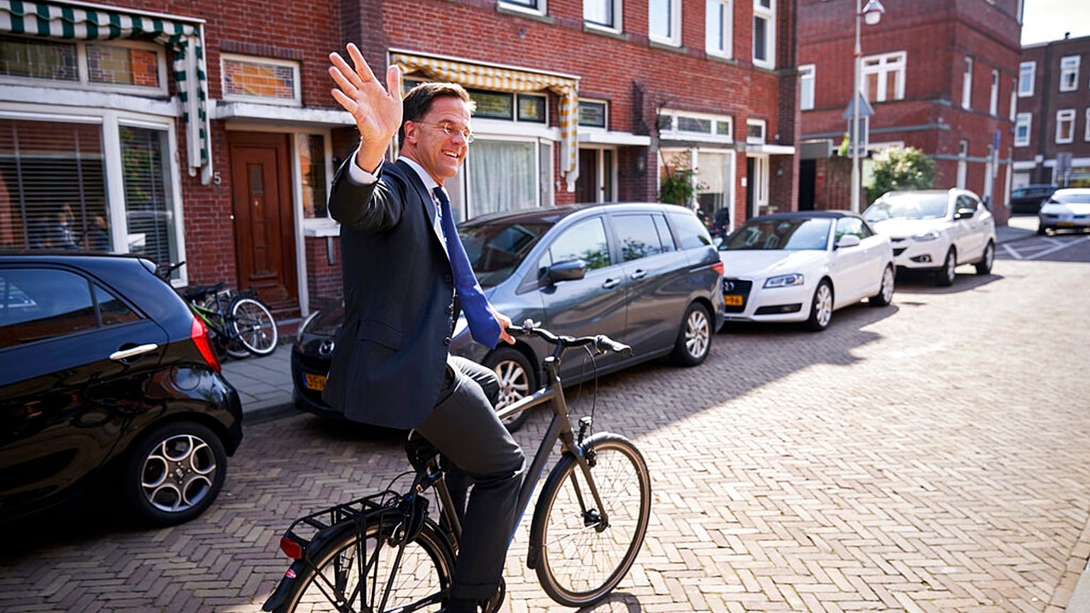 Netherlands Prime Minister Mark Rutte leaves on his bike after voting in the European elections in The Hague, Netherlands, Thursday, May 23, 2019