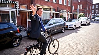 Netherlands Prime Minister Mark Rutte leaves on his bike after voting in the European elections in The Hague, Netherlands, Thursday, May 23, 2019