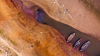 Boats in sitting on the bed of the Paraguay river amid a historic drought that is affecting its levels, in Chaco-i, Paraguay, Monday, Sept. 20, 2021.