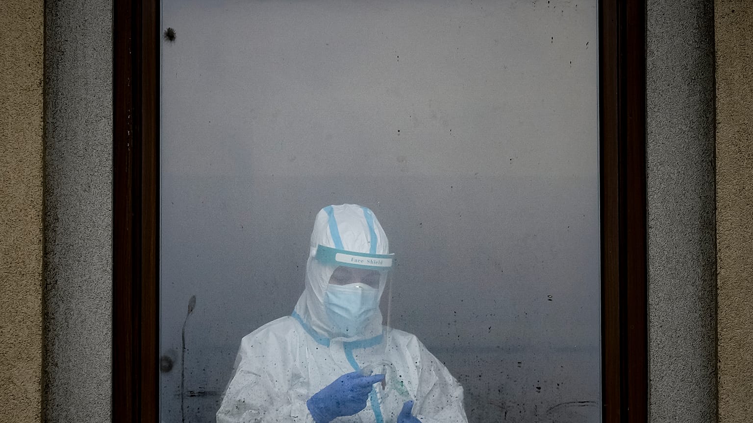 A member of the medical staff looks from a window at one of the COVID-19 dedicated sections of the Matei Bals hospital in Bucharest.