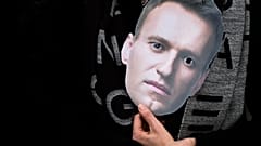 A mask of Russian opposition leader Alexei Navalny is held at a rally in Berlin.