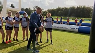 Duke and Duchess of Cambridge kick rugby balls while visiting Northern Ireland