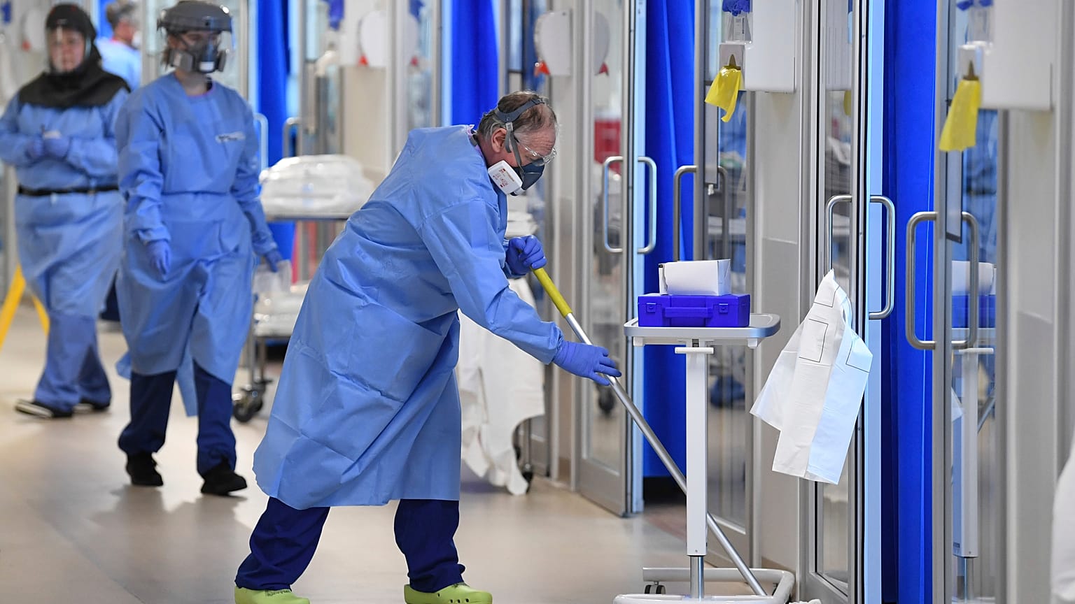 Members of the clinical staff wearing on PPE clean the intensive care unit at the Royal Papworth Hospital in Cambridge, England, Tuesday May 5, 2020.