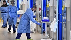 Members of the clinical staff wearing on PPE clean the intensive care unit at the Royal Papworth Hospital in Cambridge, England, Tuesday May 5, 2020.