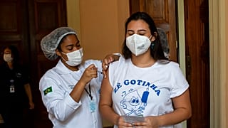 Manuela Mattar is injected with a dose of the Pfizer COVID-19 vaccine, on the first day of a vaccination campaign for 17-year-olds, at a vaccination center in Rio de Janeiro