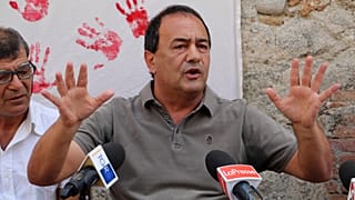 Domenico "Mimmo" Lucano is pictured in front of reporters in September 2019.