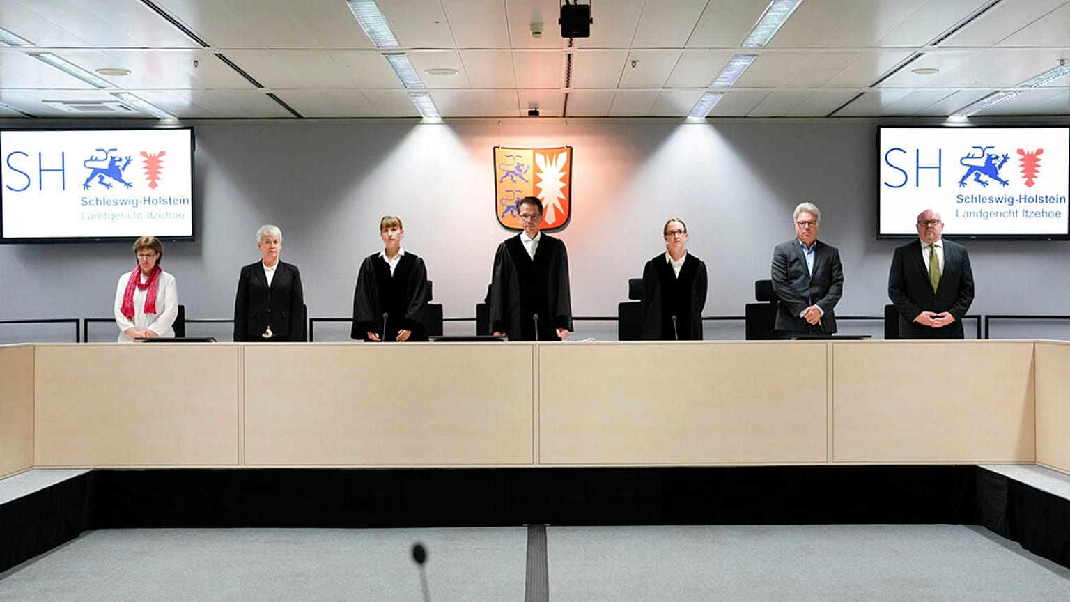 The chairman judge Dominik Gross, center, pose with the judge for media after they arrive for a trial against a 96-year-old former secretary for the SS commander of the Stutth
