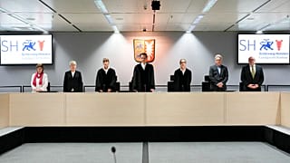 The chairman judge Dominik Gross, center, pose with the judge for media after they arrive for a trial against a 96-year-old former secretary for the SS commander of the Stutth