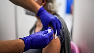 A healthcare worker administers a dose of a Covid-19 vaccine to a man at a vaccination center in Lisbon on July 2, 2021.