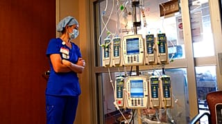 Nursing coordinator Beth Springer looks into a patient's room in a COVID-19 ward at the Willis-Knighton Medical Center in Shreveport, Louisiana. .