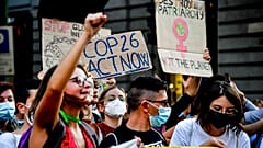People take down to the streets in the wake of the three-day Youth for Climate summit, in Milan, Italy, Saturday, Oct. 2, 2021.