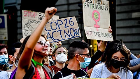 People take down to the streets in the wake of the three-day Youth for Climate summit, in Milan, Italy, Saturday, Oct. 2, 2021.