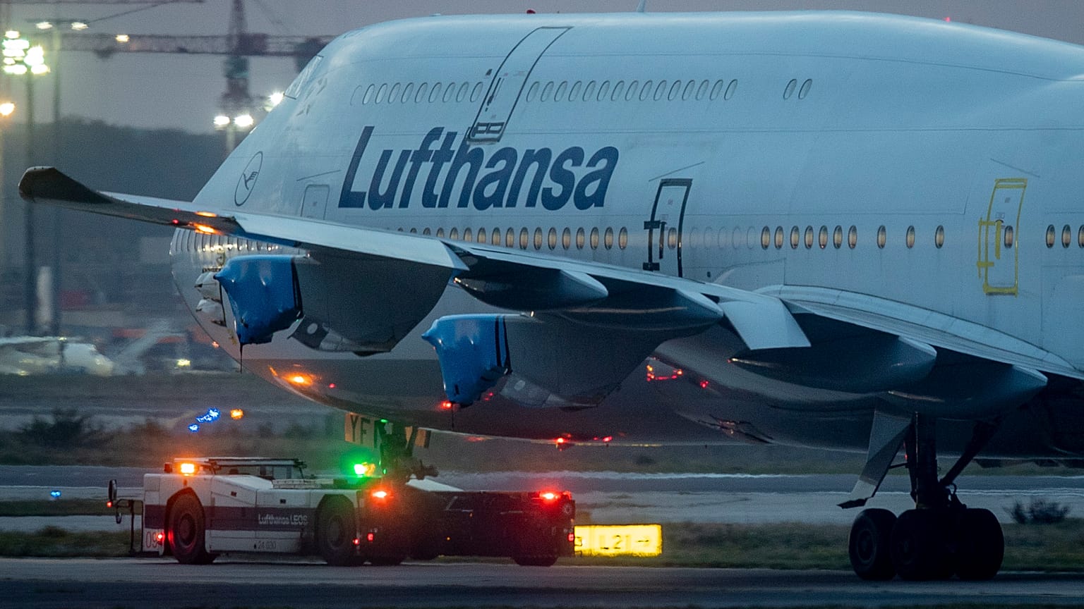 A Lufthansa Boeing 747 with covered engines is pulled to a parking position at the airport in Frankfurt, Germany, Oct. 22, 2020.