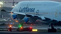 A Lufthansa Boeing 747 with covered engines is pulled to a parking position at the airport in Frankfurt, Germany, Oct. 22, 2020.