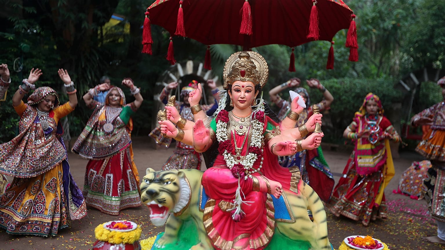 Gujarati women in traditional attire practise the Garba dance, around an idol of goddess Ambe ahead of Hindu festival of Navratri in Ahmadabad, India, Friday, Oct. 1, 2021.