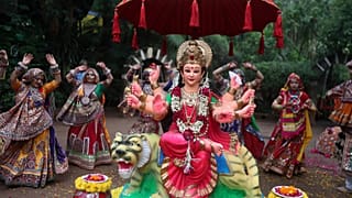 Gujarati women in traditional attire practise the Garba dance, around an idol of goddess Ambe ahead of Hindu festival of Navratri in Ahmadabad, India, Friday, Oct. 1, 2021.