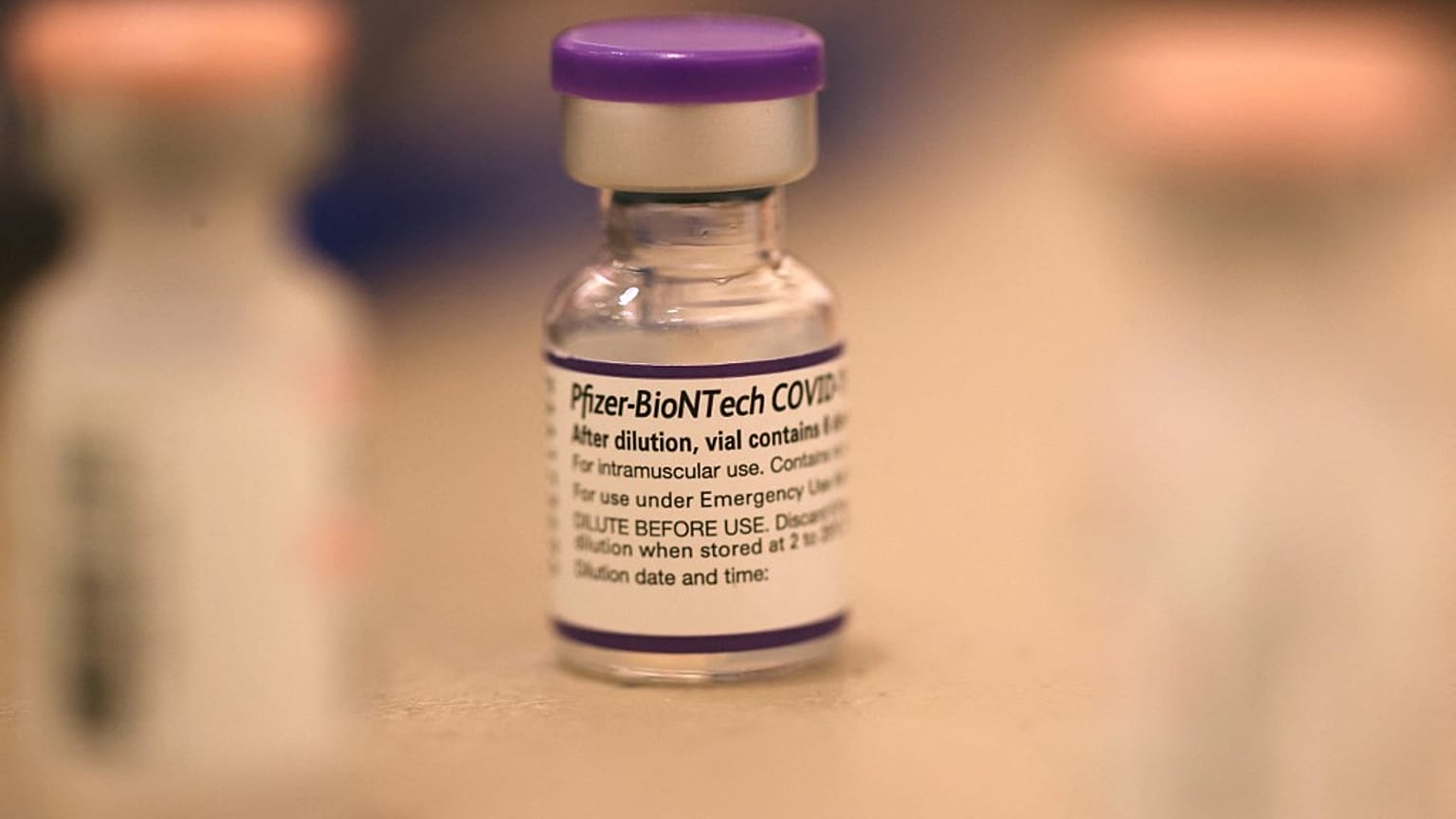 In this file photo taken on October 1, 2021, a vial of Pfizer COVID-19 booster vaccination sits on a table at a vaccination booster shot clinic in San Rafael, California.