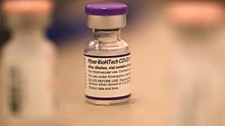 In this file photo taken on October 1, 2021, a vial of Pfizer COVID-19 booster vaccination sits on a table at a vaccination booster shot clinic in San Rafael, California.