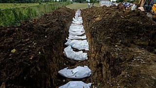 Un equipo forense entierra a un grupo de migrantes que murieron tratando de cruzar el Tapón del Darién, en el cementerio de Guayabillo en Agua Fría, Panamá, 30 de septiembre.