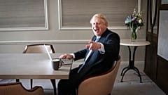 In this Oct. 5, 2021, file photo, Britain's Prime Minister Boris Johnson prepares his keynote speech in his hotel room in Manchester, England,