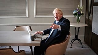 In this Oct. 5, 2021, file photo, Britain's Prime Minister Boris Johnson prepares his keynote speech in his hotel room in Manchester, England,
