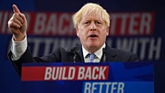 Britain's Prime Minister Boris Johnson gestures as he makes his keynote speech at the Conservative party conference in Manchester, England, Wednesday, Oct. 6, 2021.