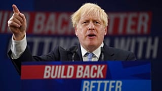 Britain's Prime Minister Boris Johnson gestures as he makes his keynote speech at the Conservative party conference in Manchester, England, Wednesday, Oct. 6, 2021.