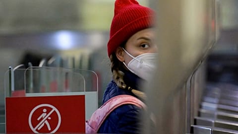 A passenger walks through a ticket gate equipped with a facial recognition fare payment system - Face Pay - at Turgenevskaya metro station in Moscow on September 23, 2021.