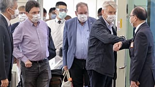 Taiwan's deputy foreign minister Harry Tseng (R) greets French Senator Alain Richard (2nd R) leading a delegation arriving at the Taoyuan international airport on October 6.
