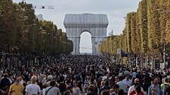 Pedestrians walking along the Champs-Elysees on Paris's car-free day 2021,