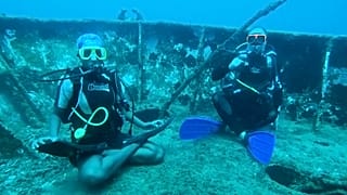 Divers practise yoga under the Caribbean sea