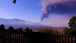 Smoke rises on the horizon as lava flows from a volcano on the Canary island of La Palma, Spain on Wednesday Oct. 6, 2021.