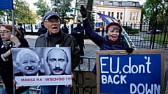 People stage a protest in front of Poland's constitutional court, in Warsaw, Poland, Thursday, October 7, 2021.