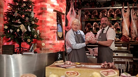 Boris Johnson holds up a turkey as he visits Darts Farm Shopping Village while campaigning for the general election, Topsham, Devon, England, November 28, 2019.