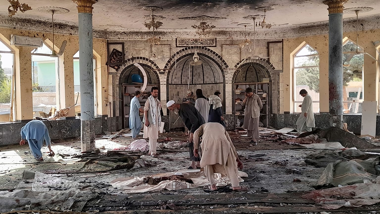 People view the damage inside of a mosque following a bombing in Kunduz, province northern Afghanistan