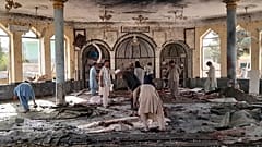 People view the damage inside of a mosque following a bombing in Kunduz, province northern Afghanistan