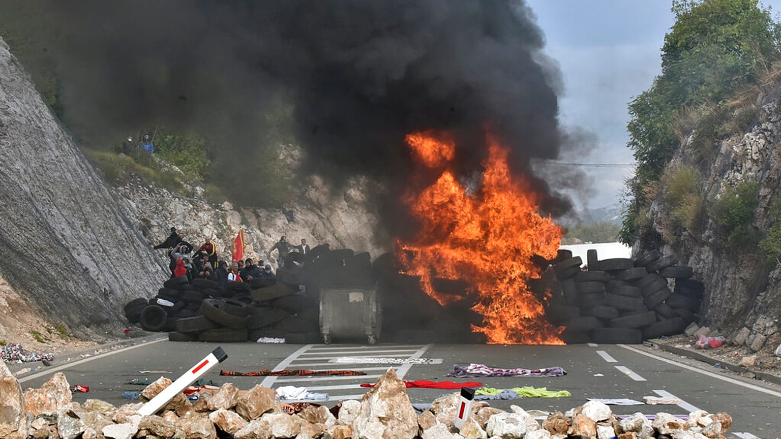 Protesters set fire to car tires at one of the blockades near Cetinje, Montenegro, Sunday, Sept. 5, 2021. 
