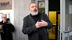 Novaya Gazeta editor Nobel Peace Prize Dmitry Muratov greets reporters at the Novaya Gazeta newspaper, in Moscow