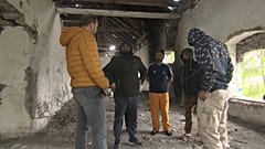 Migrants inside the abandoned farm. 