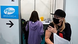 Nadhezda Pavlova from Rostov-on-Don leaves after a vaccination at Belgrade Fair makeshift center in Belgrade, Serbia, Saturday, Oct. 2, 2021. 