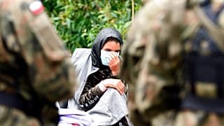 Migrants are seen after crossing the border from Belarus into Poland in the village of Usnarz Gorny, Poland, on Thursday Aug.19, 2021.