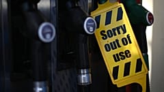 An out of use sign is attached to a pump at an Esso petrol station in east London on September 24