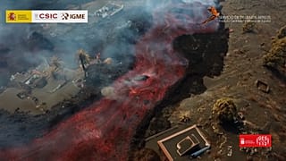 Aerial of lava flow with large rocks moving