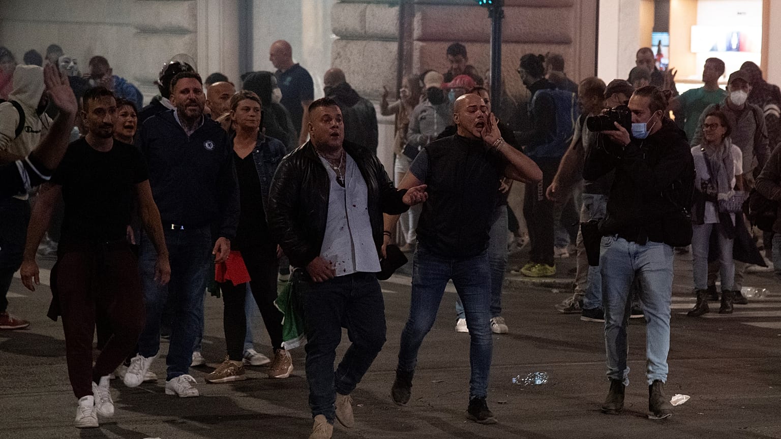 Forza Nuova leader Giuliano Castellino (C) shout during clashes after a protest against the compulsory "green pass" to limit the spread of COVID-19, Rome, October 9, 2021.