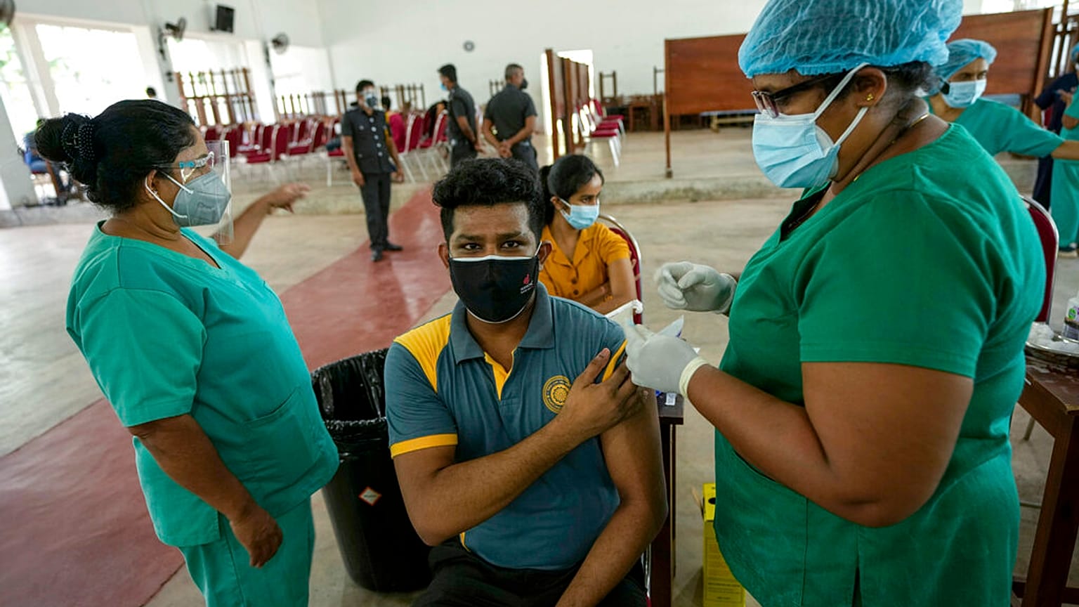A Sri Lankan university student receives his coronavirus vaccine at the Sri Jayawardenapura university in Colombo, Sri Lanka, Monday, Oct. 11, 2021. 